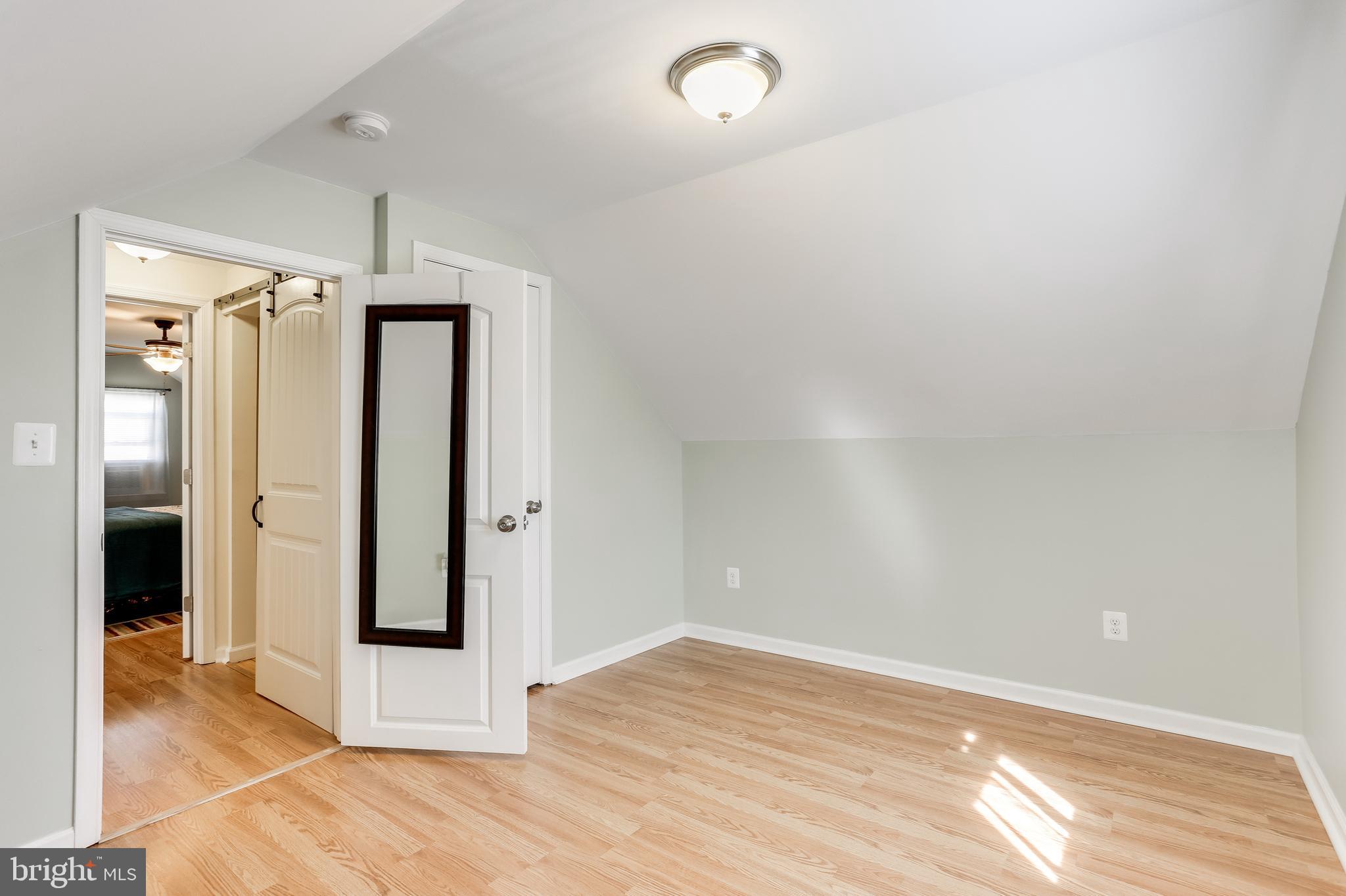 1809 Briarcliff Road Baltimore, MD 21234 - Photo 15 of 33 an empty room with wooden floor and windows