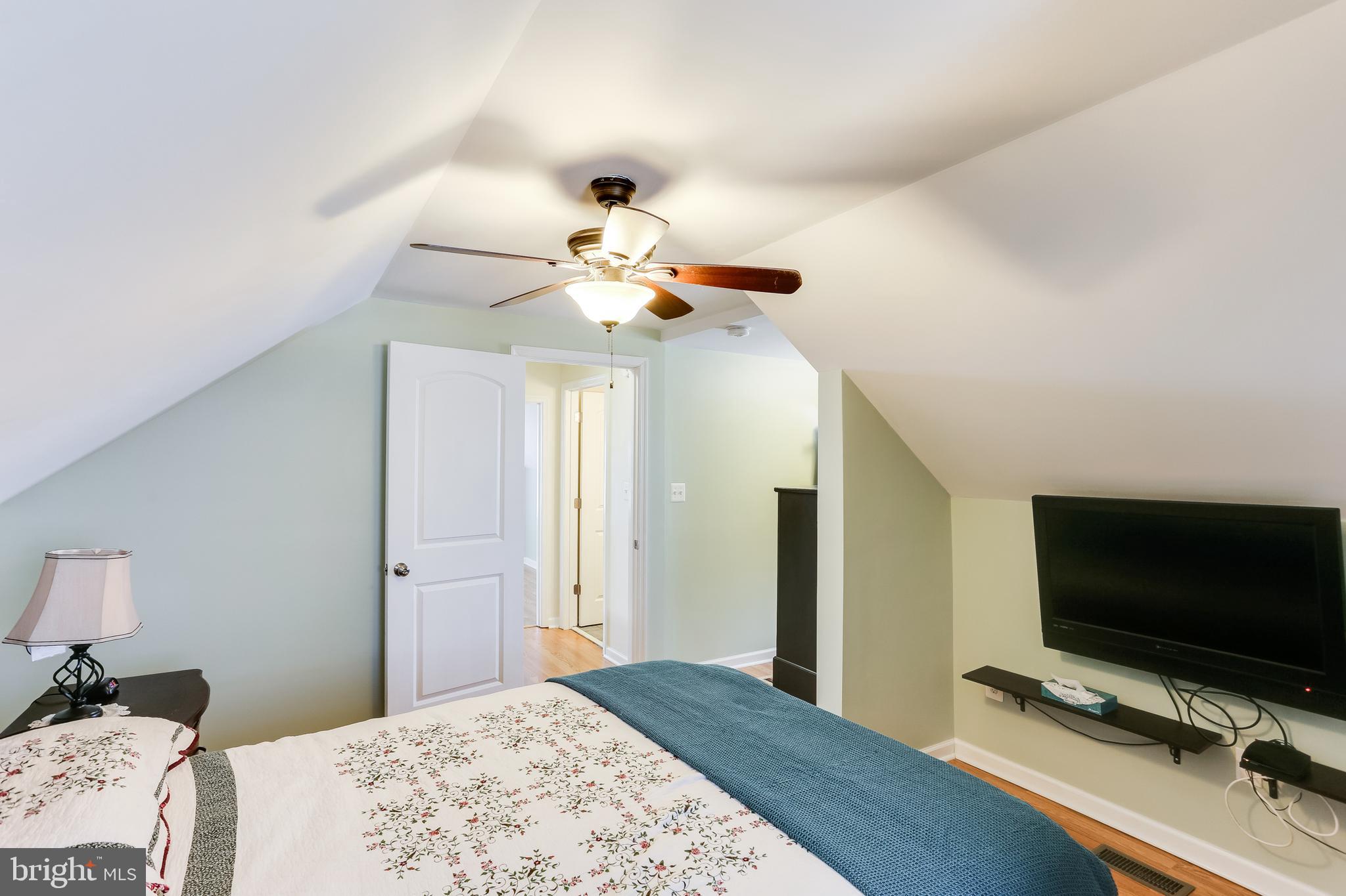 1809 Briarcliff Road Baltimore, MD 21234 - Photo 18 of 33 a bedroom with a bed and a flat screen tv