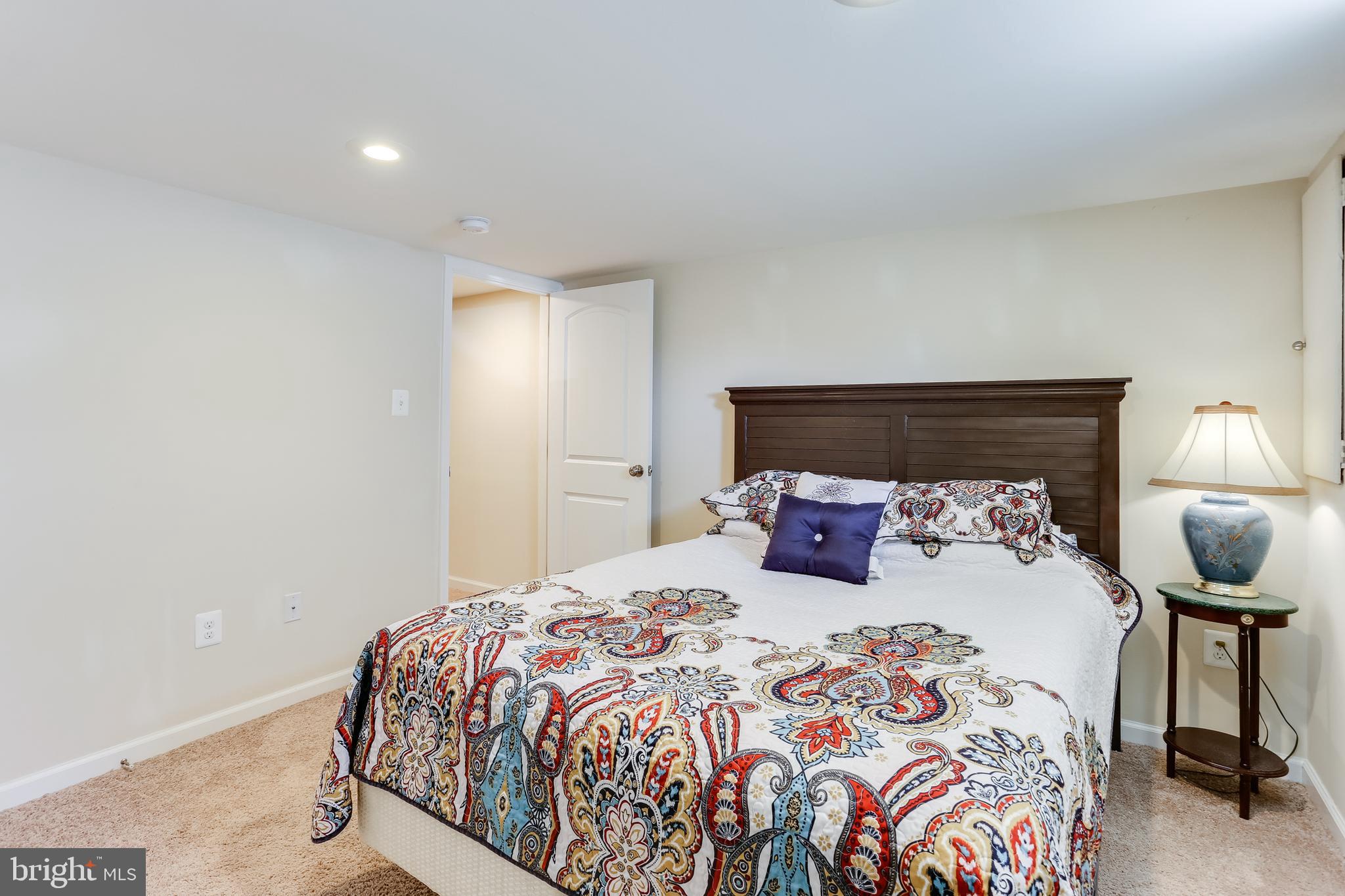 1809 Briarcliff Road Baltimore, MD 21234 - Photo 22 of 33 a bedroom with a bed and a lamp
