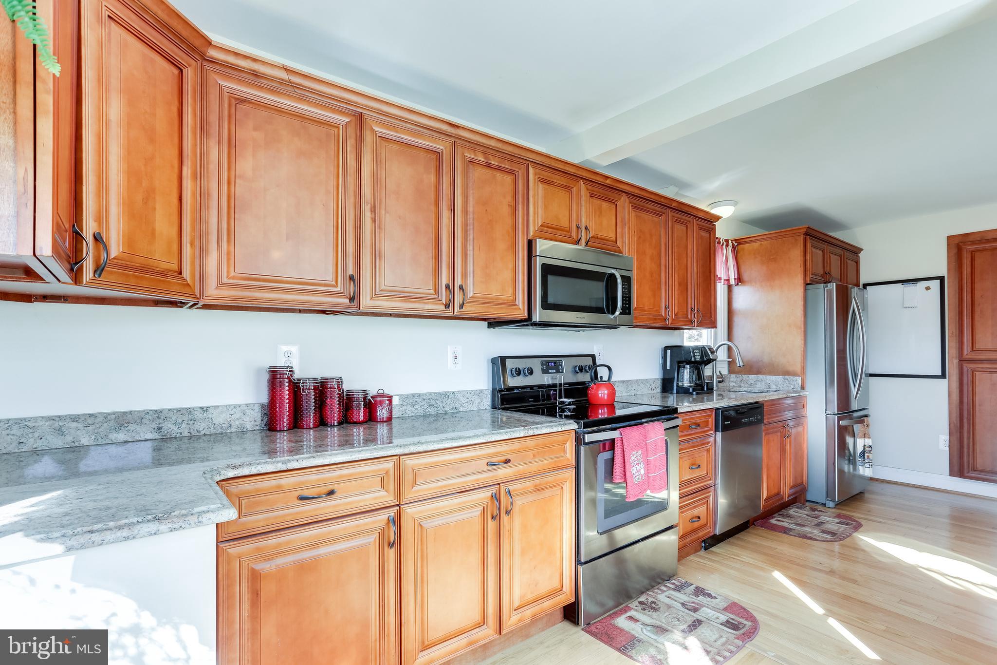 1809 Briarcliff Road Baltimore, MD 21234 - Photo 7 of 33 a kitchen with stainless steel appliances granite countertop a refrigerator sink and cabinets