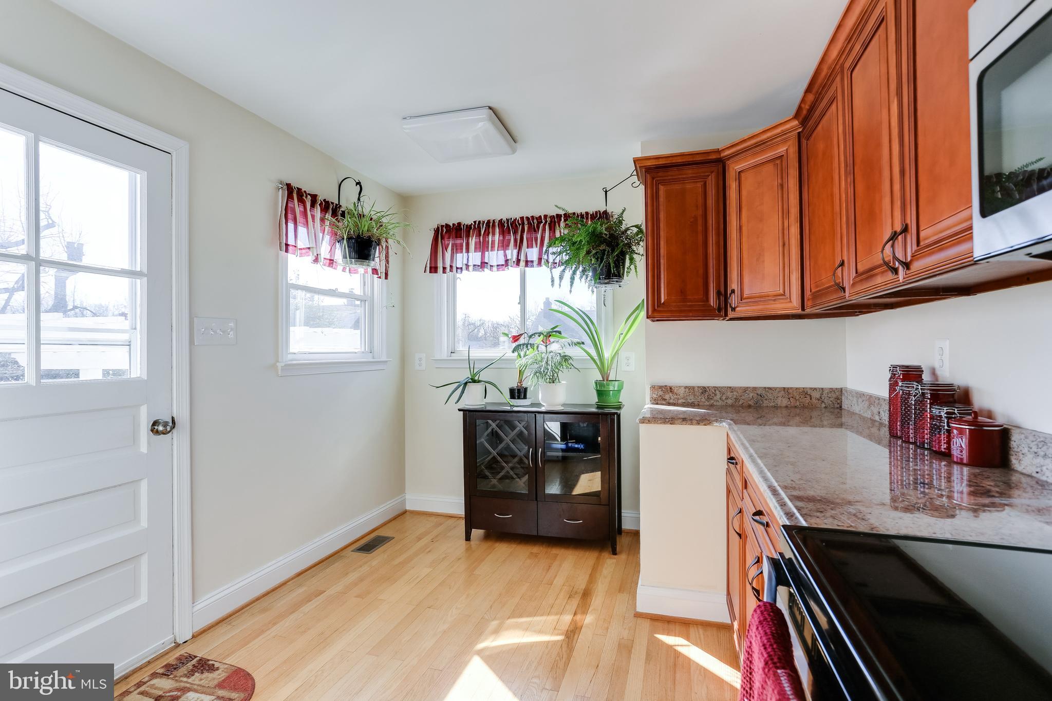 1809 Briarcliff Road Baltimore, MD 21234 - Photo 8 of 33 a kitchen with granite countertop a sink cabinets and window