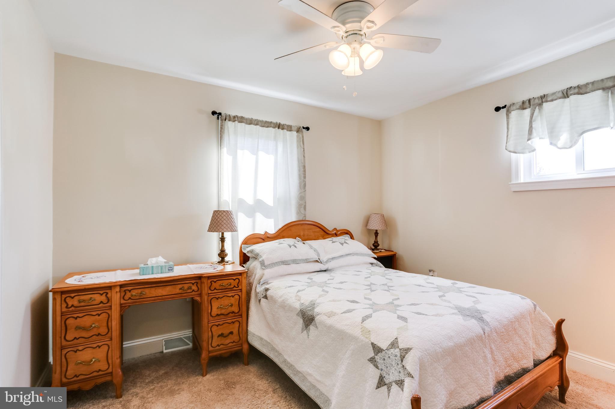 1809 Briarcliff Road Baltimore, MD 21234 - Photo 9 of 33 a bedroom with a bed and a chandelier