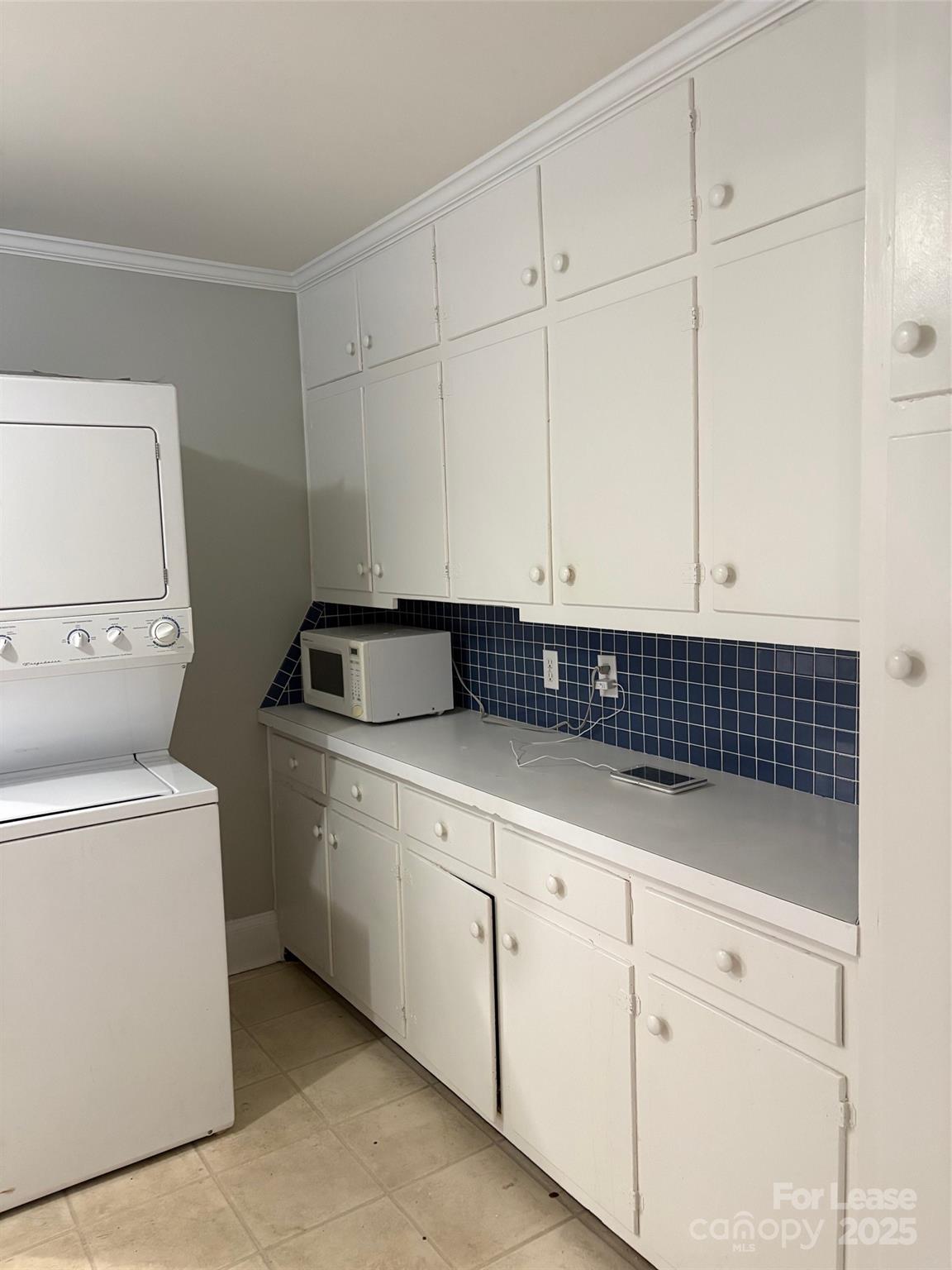 808 West Franklin Street Monroe, NC 28112 - Photo 4 of 9 a kitchen with white cabinets and sink
