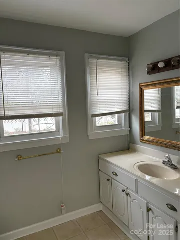 a bathroom with 2 sink and a window