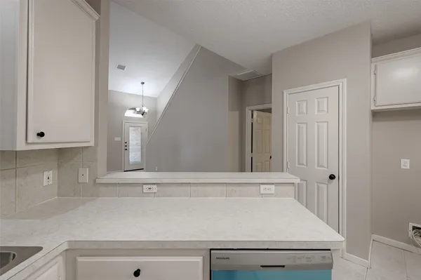 a view of room with granite countertop cabinets
