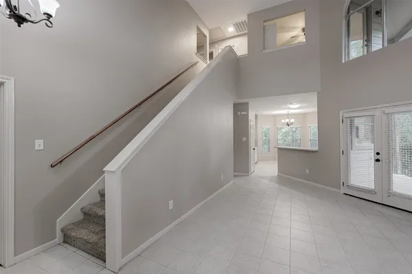 a view of hallway with stairs and a bathroom