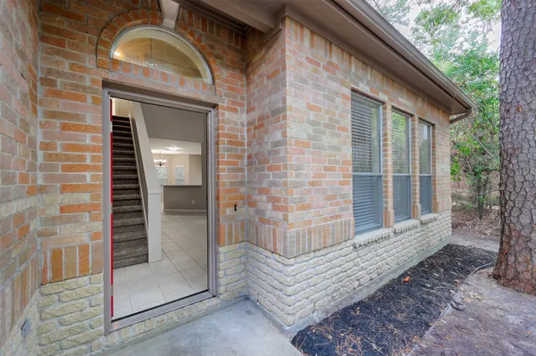 a view of front door of house with a yard