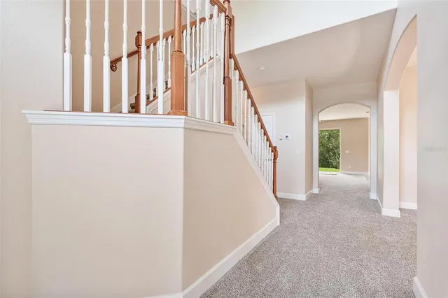 a kitchen with stainless steel appliances granite countertop a refrigerator a sink a stove a microwave and island with wooden floor