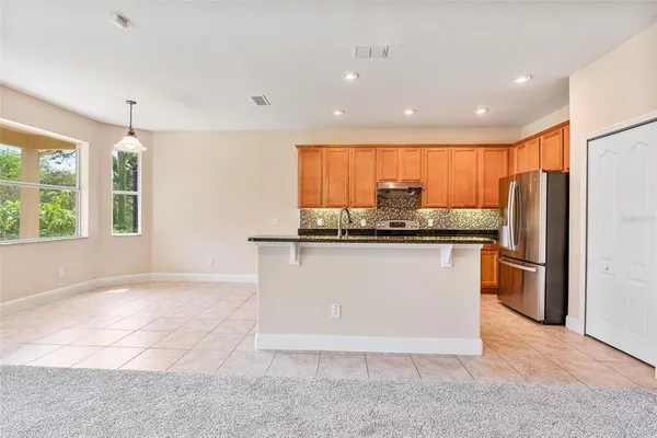 a spacious bathroom with a granite countertop sink mirror and bathtub