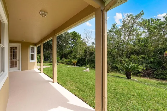 a view of an empty room with a chandelier fan