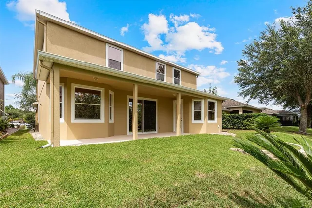an empty room with chandelier fan and closet area