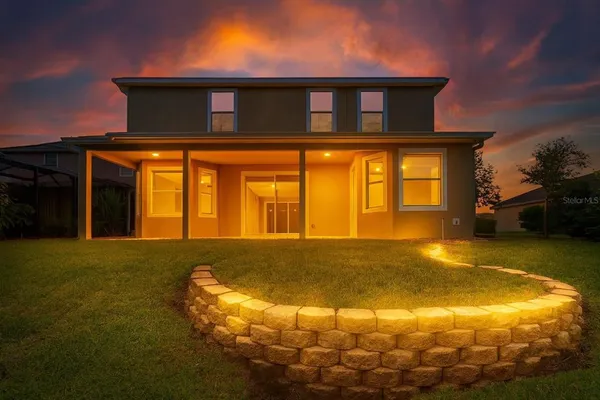 a bathroom with a granite countertop sink and a large mirror