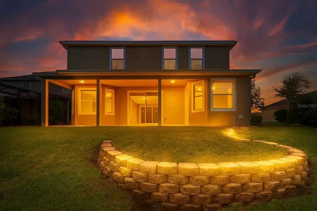a bathroom with a granite countertop sink and a large mirror
