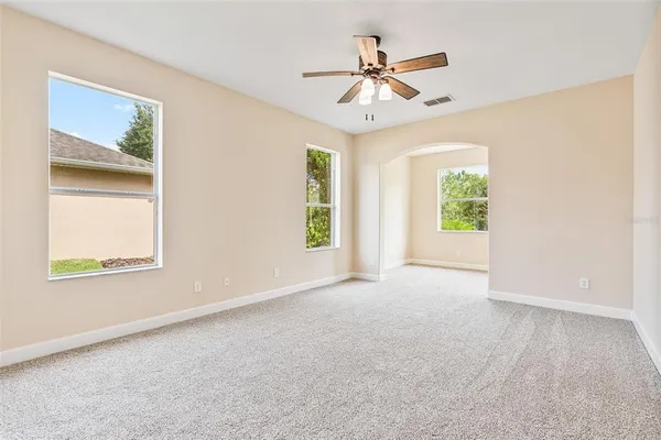 a view of an empty room with window and bathroom