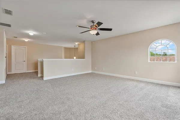 a view of a house with large windows and a small yard