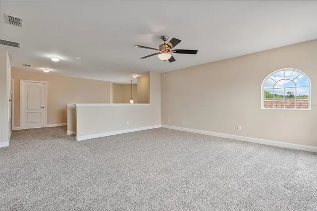 a view of a house with large windows and a small yard