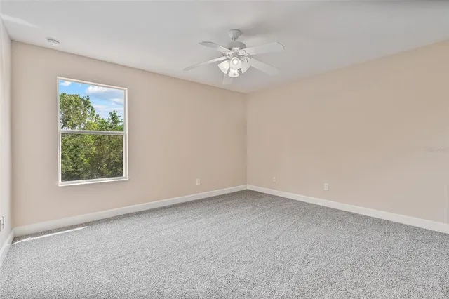 a view of a hallway with closet and a window