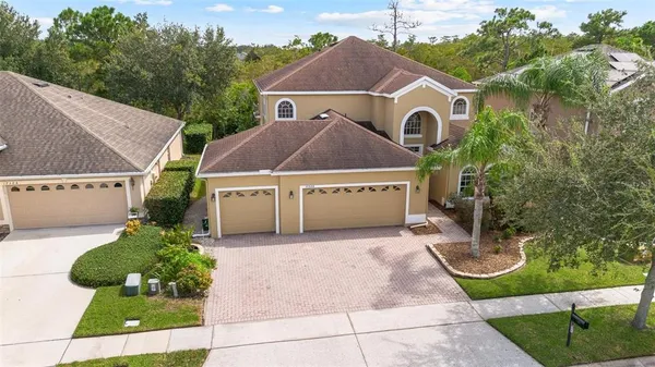 a house with green field in front of it