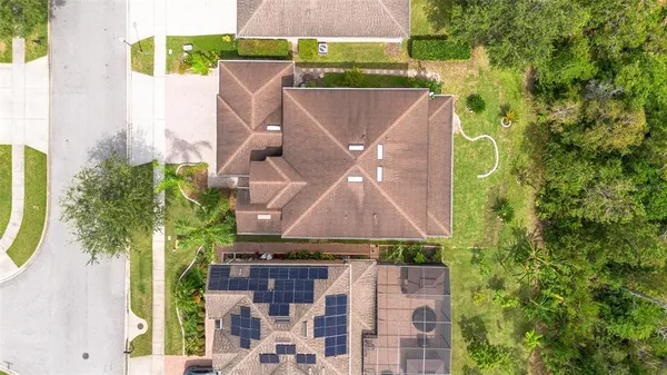 a view of an empty room with wooden floor and stairs