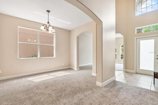 an empty room with large windows