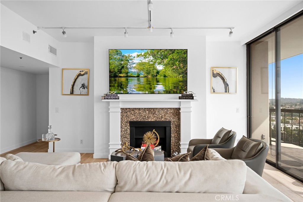 222 Monterey Road, Unit 1603 Glendale, CA 91206 - Photo 11 of 65 a living room with furniture and a fireplace