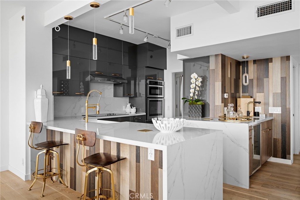 222 Monterey Road, Unit 1603 Glendale, CA 91206 - Photo 17 of 65 a kitchen with kitchen island granite countertop a sink cabinets and stainless steel appliances