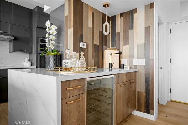 a kitchen with stainless steel appliances granite countertop a sink a stove and a refrigerator