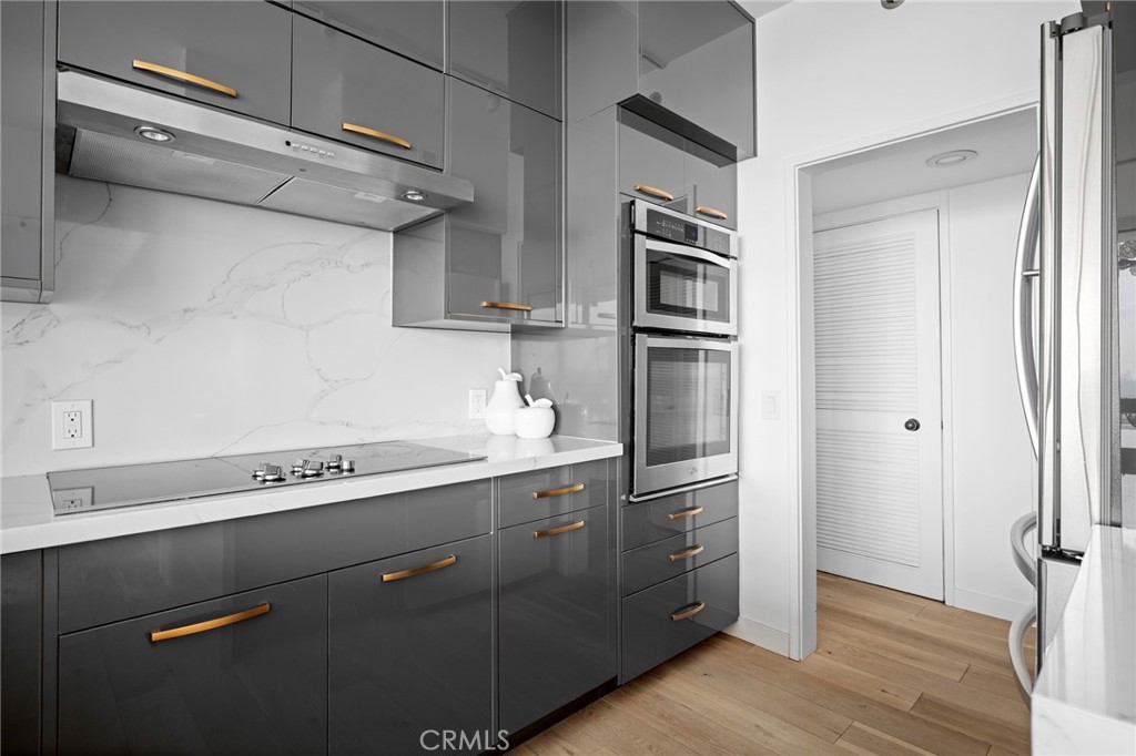 222 Monterey Road, Unit 1603 Glendale, CA 91206 - Photo 20 of 65 a kitchen with stainless steel appliances a sink and wooden floor