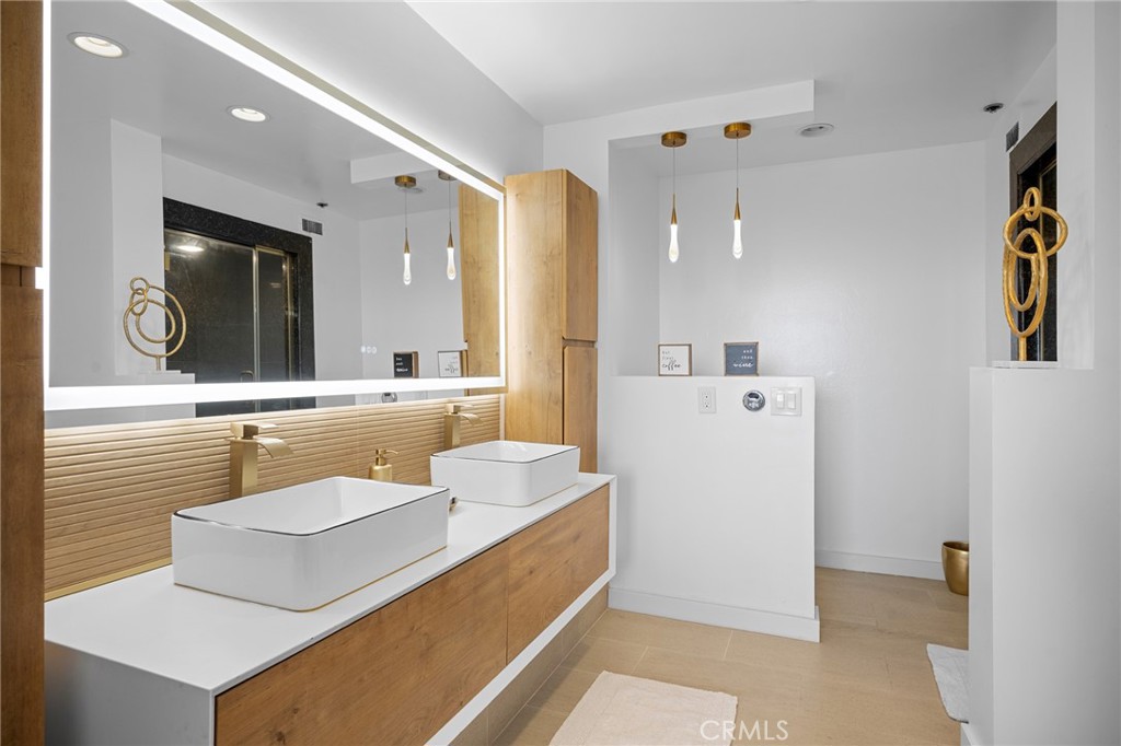 222 Monterey Road, Unit 1603 Glendale, CA 91206 - Photo 26 of 65 a bathroom with a sink a mirror and a shower