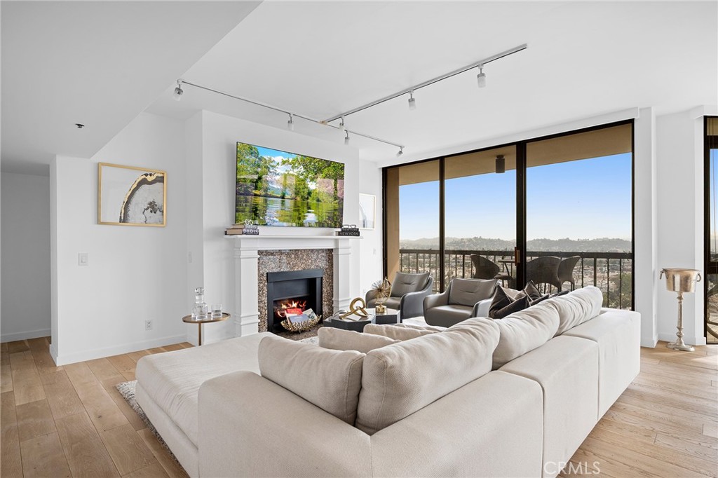 222 Monterey Road, Unit 1603 Glendale, CA 91206 - Photo 6 of 65 a living room with furniture fireplace and a large window