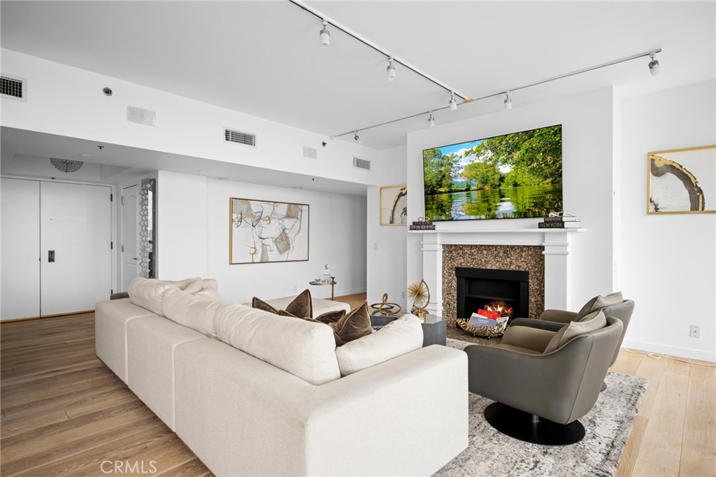 222 Monterey Road, Unit 1603 Glendale, CA 91206 - Photo 10 of 65 a living room with furniture and a fireplace