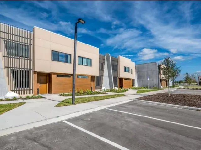 a city street lined with buildings and trees