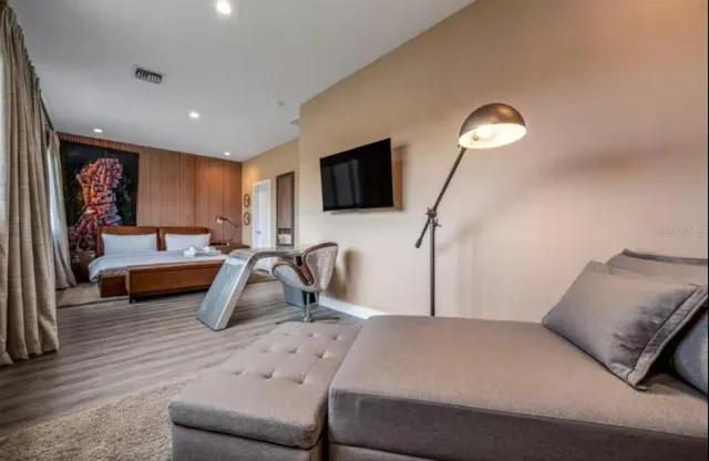 a bedroom with a bed and a flat screen tv