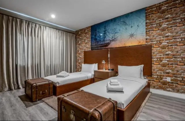 a bedroom with two beds and a dresser