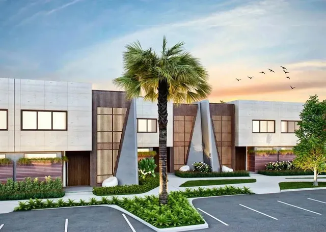 a front view of multi story residential apartment building with yard and green space