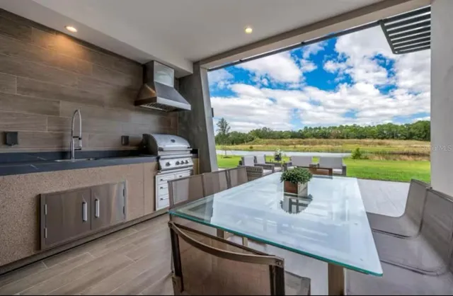 a kitchen with a table chairs and stove in it