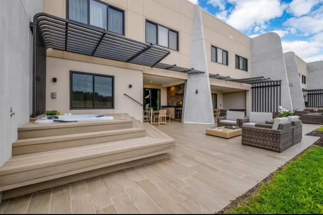 a view of the patio with couches chairs and a table