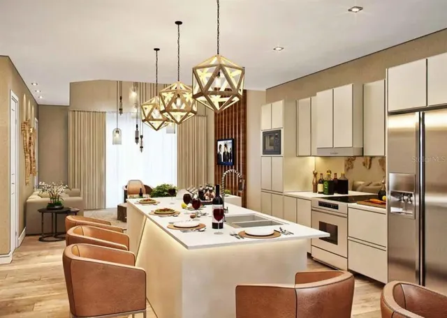 a kitchen with stainless steel appliances granite countertop a sink a stove and a refrigerator