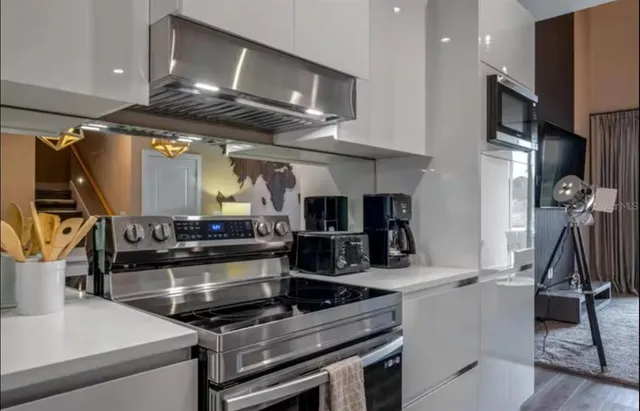 a kitchen with stainless steel appliances granite countertop a stove and a sink