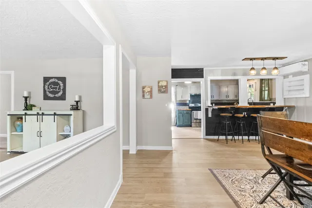 a kitchen with stainless steel appliances kitchen island granite countertop a refrigerator and cabinets