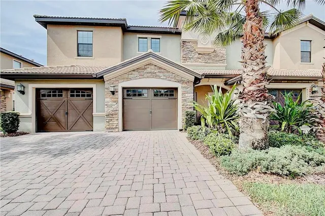 a front view of a house with a yard and a garage