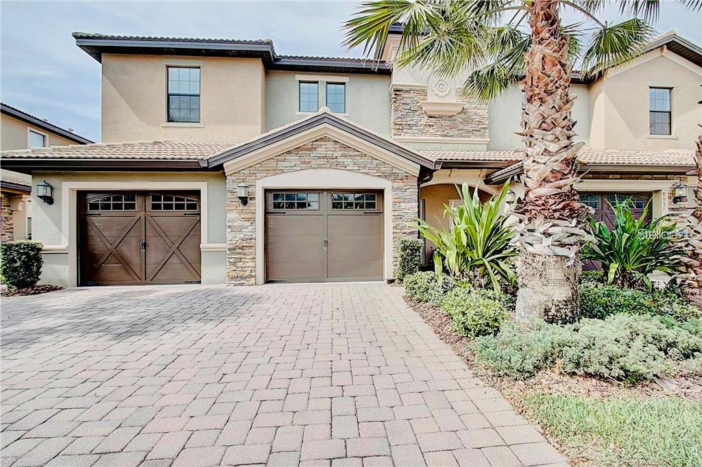 9020 Azalea Sands Lane Davenport, FL 33896 - Photo 1 of 16 a front view of a house with a yard and a garage