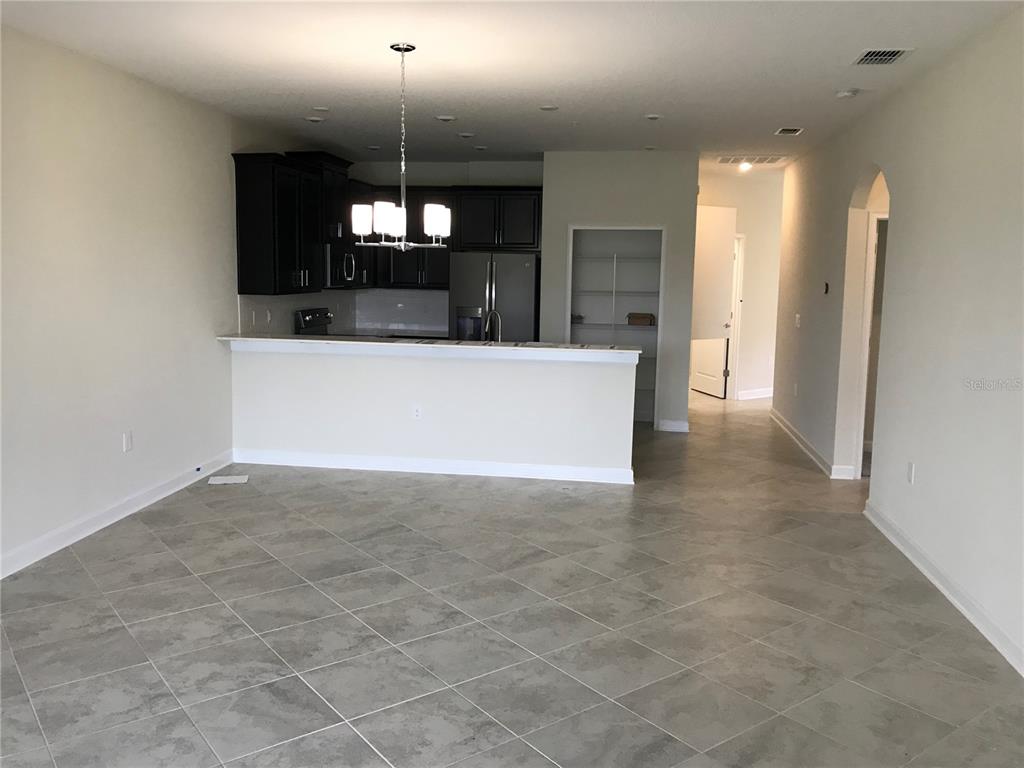9020 Azalea Sands Lane Davenport, FL 33896 - Photo 2 of 16 a view of a hallway with a chandelier