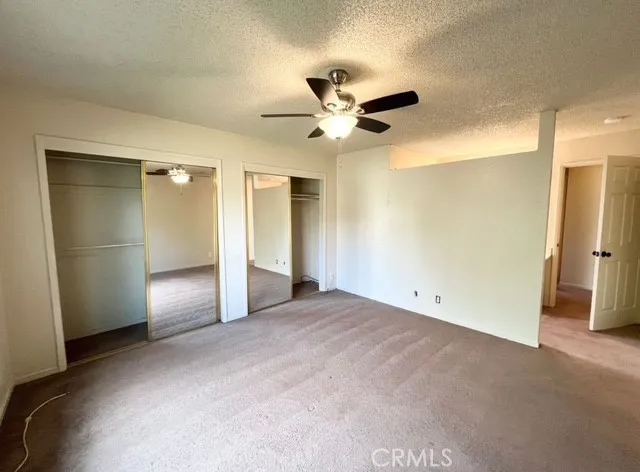 a view of empty room with ceiling fan