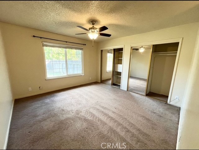 3056 Bedford Drive Merced, CA 95340 - Photo 15 of 19 an empty room with chandelier fan and windows