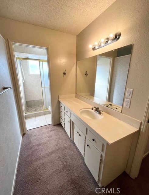 3056 Bedford Drive Merced, CA 95340 - Photo 16 of 19 a bathroom with a double vanity sink mirror and bathtub
