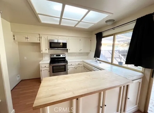 a kitchen with a stove a sink and a refrigerator