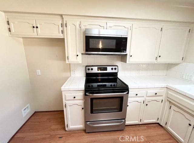 3056 Bedford Drive Merced, CA 95340 - Photo 5 of 19 a kitchen with a stove and a microwave