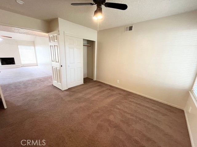 3056 Bedford Drive Merced, CA 95340 - Photo 10 of 19 an empty room with a ceiling fan and carpet