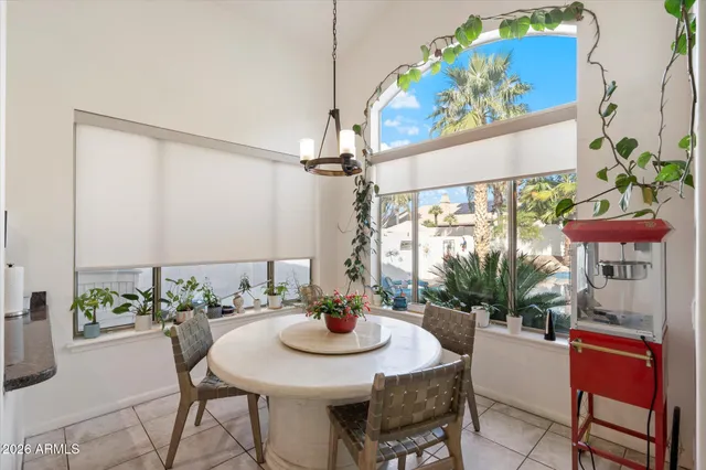 a view of a dining room with furniture a chandelier and wooden floor